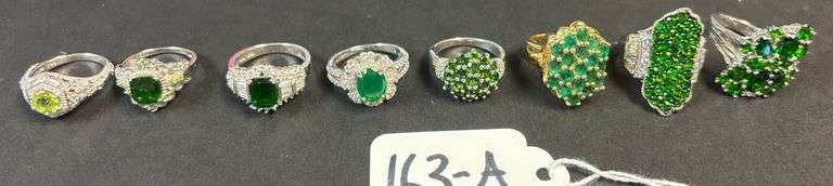 8 STERLING RINGS W/ EMERALD TYPE STONES - 1.29 TROY OZ, 40.22 GRAMS INCLUDING STONES - SIZES RANGE FROM 5 1/2-7 image