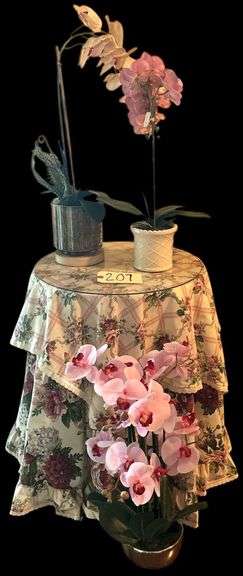 THREE LARGER POTTED ARTIFICIAL ORCHID ARRANGEMENTS - TALLEST IS APP. 29 INCHES TALL, OTHERS 22 INCHES TALL - ROUND PARTICLEBOARD TABLE WITH GLASS TOP AND FLORAL SKIRT INCLUDED image