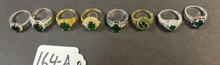 8 STERLING RINGS W/ EMERALD TYPE STONES, VARYING DESIGNS - 31.40 GRAMS, 1.01 TROY OZ - SIZES RANGE FROM 5-7 image
