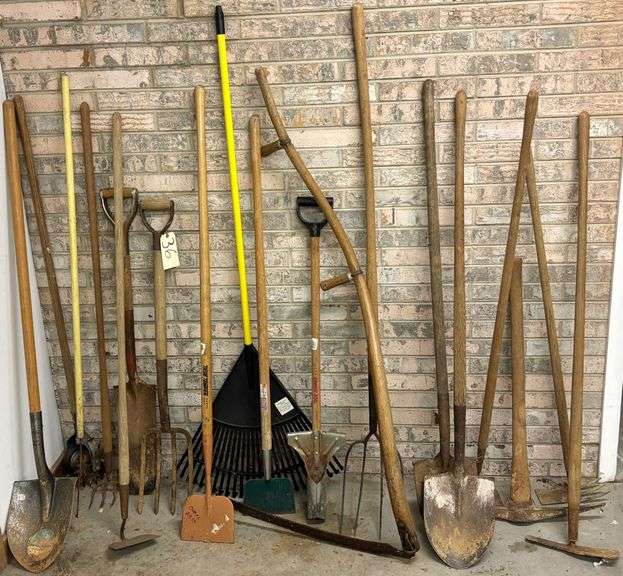 ASSORTMENT OF HAND TOOLS TO INCLUDE PITCH FORKS, SPADE SHOVELS, LEAF RAKE, PICKAXE, HOES, HAND CULTIVATOR, SCYTHE, ETC. image