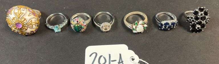 7 STERLING SILVER RINGS, 2 W/ BLACK ONYX TYPE STONES, 1 PEARL STAR SHAPE, 1 EMERALD W/ MULTICOLOR, 1 SKY BLUE SAPPHIRE, LARGE W/ PURPLE AMETHYST STONE AND GOLD TONE - 1.29 TROY OZ, 40.33 GRAMS - SIZES 5-8 image