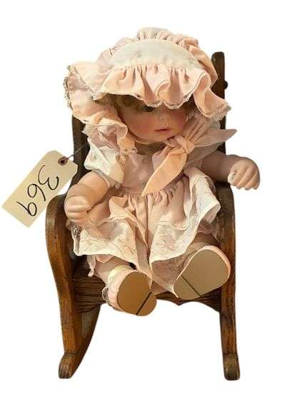 PORCELAIN DOLL IN OAK DOLL ROCKER - ROCKER MEASURES 13.5" TALL X 9.5" WIDE AT ARMS image