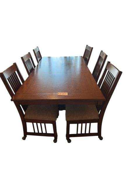 WOODEN MISSION STYLE DINING TABLE APPROX. 84” X 42” W/ 6 MATCHING CHAIRS ON ROLLERS image