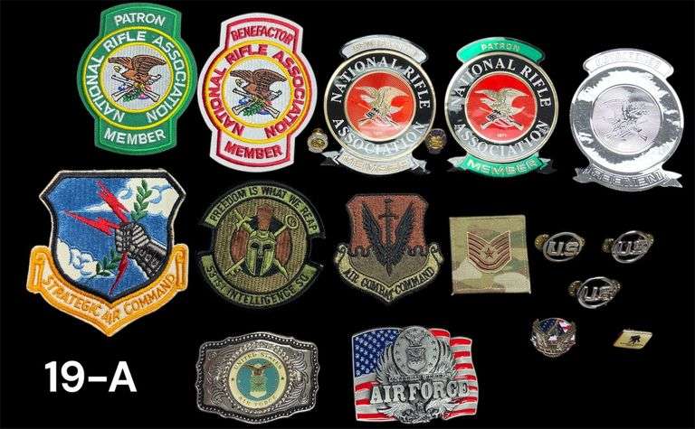 TWO UNITED STATES AIR FORCE BELT BUCKLES (MADE IN USA), ASSORTED PATCHES TO INCLUDE STRATEGIC AIR COMMAND, 531ST INTELLIGENCE SQ, AIR COMBAT COMMAND, TECH. SERGEANT, 3 U.S. SHIRT/HAT PINS, VETERAN PIN, WOUNDED WARRIOR PROJECT PIN, TWO NRA PATCHES AND PINS, 3 STICKERS image