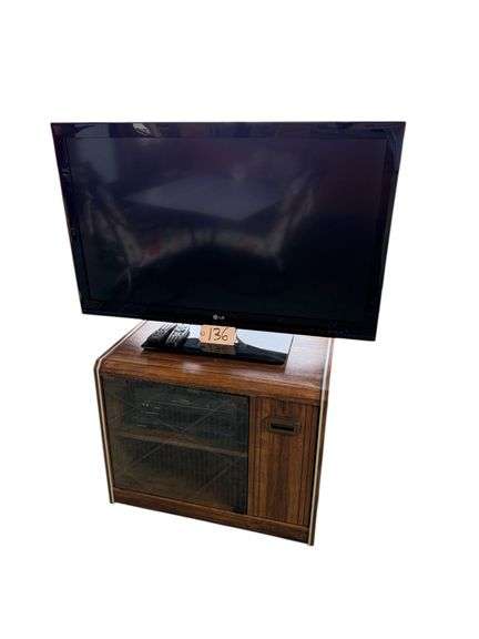 LG 42” TELEVISION, TOSHIBA VCR, MAGNAVOX BLU-RAY PLAYER, DESK LIGHT, WOODEN ENTERTAINMENT STAND W/ GLASS DOOR image