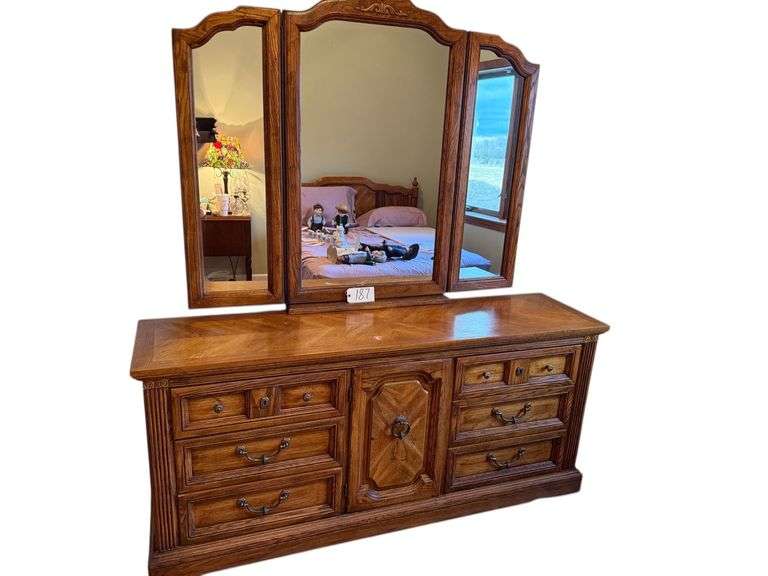 WOODEN DRESSER W/ 6 DRAWERS, 1 DOOR W/ 3 DRAWERS INSIDE - APPROX. 70” WIDE X 31.25” TALL X 18” DEEP - W/ TRI-FOLD MIRROR - MATCHES LOT #189 image