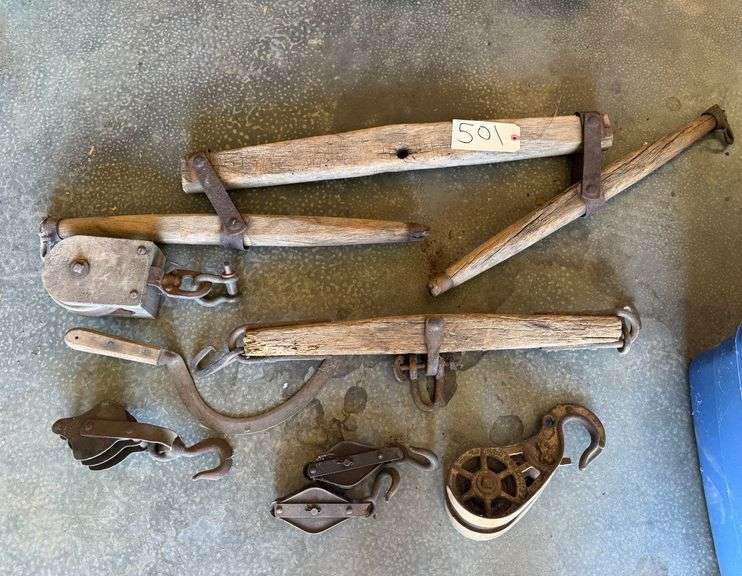 COLLECTION OF ANTIQUE PRIMITIVE WOODEN AND WROUGHT IRON FARM IMPLEMENTS, LIKELY FOR A HORSE OR OX HARNESS, INCLUDING SINGLE TREES (SWINGLETREES) AND VARIOUS PULLEYS image