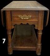 APPEARS TO BE OAK DROP-LEAF END TABLE WITH DRAWER AND BRASS PULL