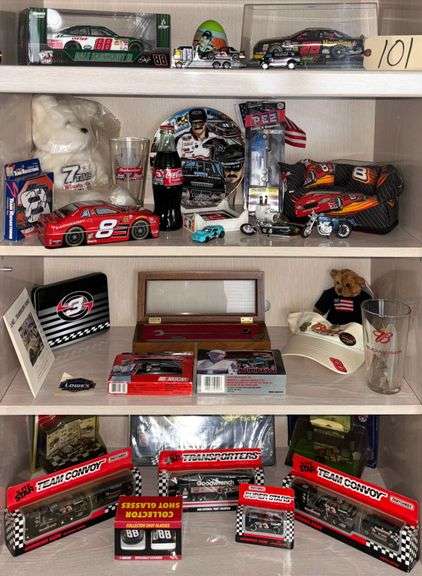 LOT OF NASCAR MEMORABILIA - MOSTLY DALE EARNHARDT SR. & JR.  - 6 1:64 SCALE DIECAST CARS, 3 1:64 SCALE HAULERS, COLLECTORS' PLATE, PEZ DISPENSER, PLAYING CARDS, COMMEMORATIVE WRENCH, VISOR, DRINKING GLASS, SHOT GLASSES, HOODIE, RACING JACKET, CALENDARS, DUFFEL BAG, FANNY PACK, LIFE SIZE POSTER, FRAMED PRINT, 1:24 SCALE DALE JR. CAR, AND MORE; 1:24 SCALE ERNIE IRVAN HAVOLINE CAR ALSO INCLUDED image