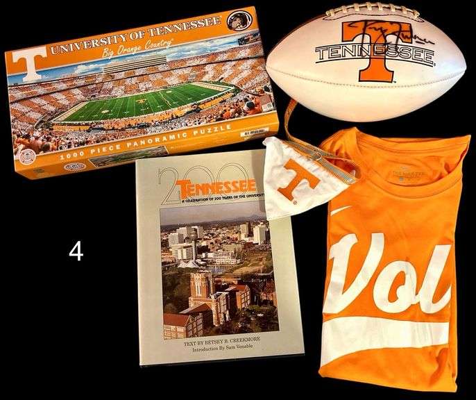 PHILLIP FULMER AUTOGRAPHED FOOTBALL WITH UNIVESITY OF TENNESSEE LOGO (SIGNATURE NOT OFFICIALLY AUTHENTICATED), NEYLAND STADIUM FOOTBALL PUZZLE, VOLS BASEBALL NIKE SHIRT SIZE LARGE, TENNESSEE SMALL PET BANDANA, 200 YEARS TENNESSEE BOOK image