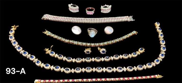 LOT OF 925 SILVER: BRACELET, EARRINGS, AND RING SET W/ PINK STONES; RING AND EARRINGS SET W/ PEARLIZED STONES; GOLD WASHED BRACELET; NECKLACE; EARRINGS SET; GOLD WASHED BRACELET W/ LIGHT BLUE STONES; GOLD WASHED BRACELET W/ RUBY COLOR STONES - 5 TROY OZ/156.28 GRAMS INCLUDING STONES image