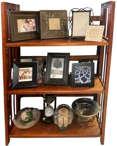WOODEN 3-TIER SHELF W/ ASSORTED PICTURE FRAMES, GLASS ANGEL, OTHER GLASSWARES, HOURGLASS, ETC. image
