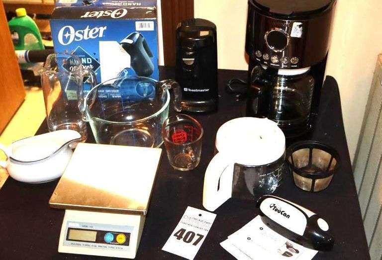 Variety of Kitchen Items: New Cuisinart 12 Cup Coffee Pot, New Oster Hand Mixer, Toast Master Can Opener, Toucan Can Opener, Measuring Bowl, Pitcher, Creamer, Scale, Extra Pots and filter etc. image