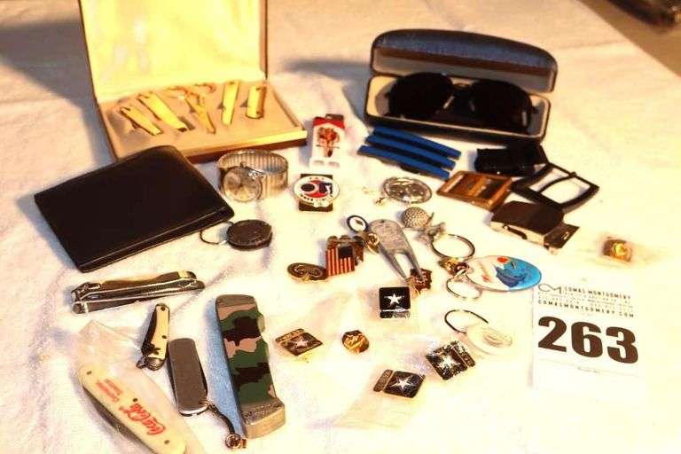 Variety of Men's items: Wallet, Belt Buckles, Lighter, Knives, Keychains, Pins,  Sunglasses, Etc. image