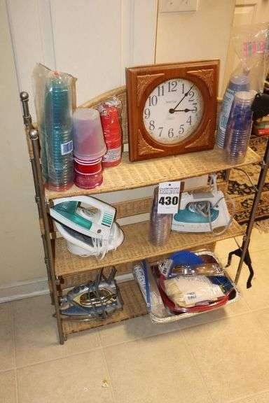 Wicker Shelf with 3 shelves (34"x28"x8"), Wall Clock, 3 irons, variety of plastic cups, plates, flatware                             **Buyer may want to bring box  for items image