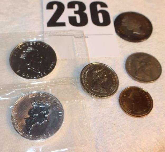 Variety of Coins & Coin items: 2 50¢ coins, 2 Silver $1.00, Gold Dollar, 2 1oz. Silver coins, & $5.00 coin image