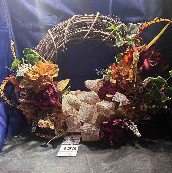 Grape Vine with Tan / Cream Bow has the feathers and orange  flowers image