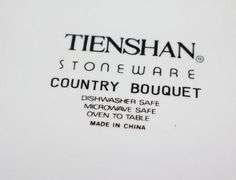 Set of "Tienshan Stoneware "Country Bouquet": 8 dinner plates, 7 dessert plates, 8 bowls, 8 cups, 8 saucers, 3 piece canister set & salt and pepper set