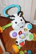 Variety of Kid Items: High Chair (needs a good cleaning), Seat, Toys, Jumpy Swing, Books, Etc.