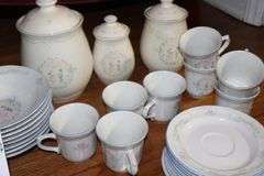 Set of "Tienshan Stoneware "Country Bouquet": 8 dinner plates, 7 dessert plates, 8 bowls, 8 cups, 8 saucers, 3 piece canister set & salt and pepper set