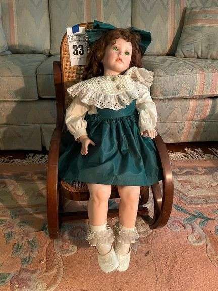 Porcelain Doll with Green Dress and Rocking Chair image