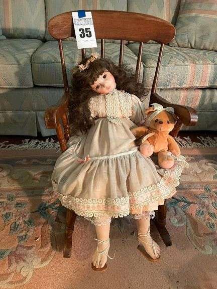 Porcelain Doll with Teddy Bear in Rocking Chair image