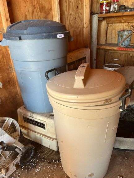 Small pet carrier and two plastic trash cans image