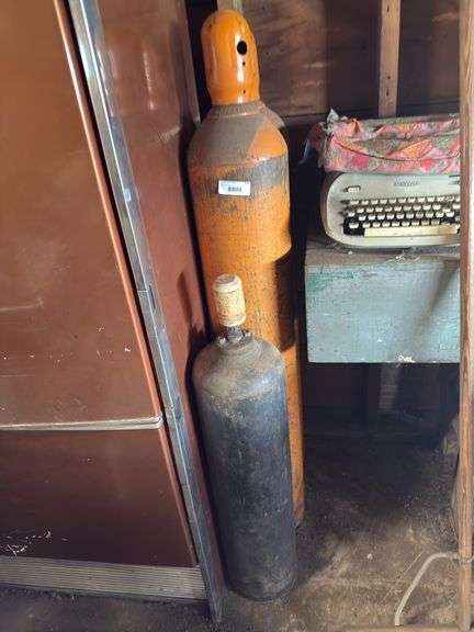 Mixed Lot: Two Large Orange Gas Cylinders and a Smaller Black Cylinder image