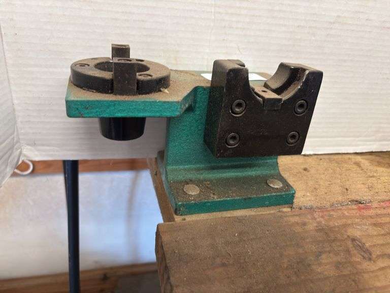 CNC (Computer Numerical Control) tool holder tightening fixture. It is used to securely hold CNC tool holders during tool changes and maintenance. image