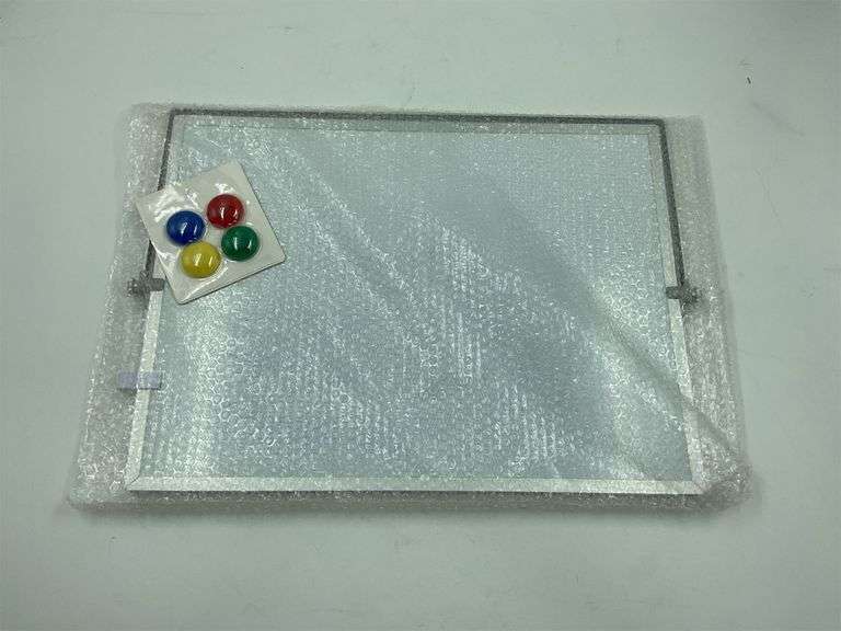 White board with 4 colorful magnets image