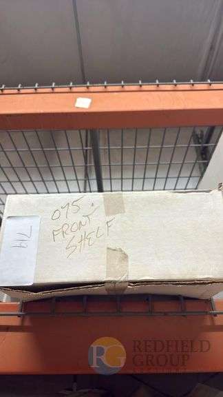 Boxed Item with Handwritten Note "075 FROM SHELF" on Brown Cardboard image
