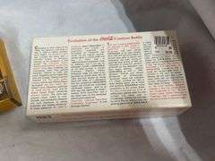 Coca-Cola Collectibles: Wooden Crate with Bottles and "Evolution of Contour Bottle" Set