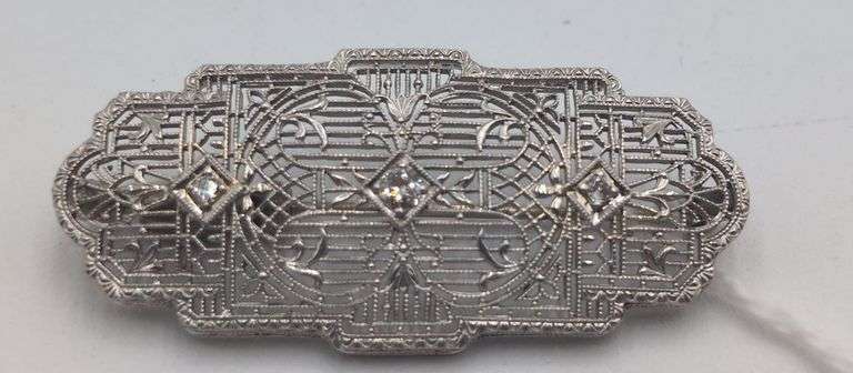 14K white gold and platinum filigree style diamond brooch. image