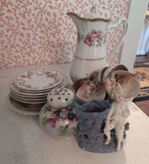 Collectible Porcelain Tea Set with Pitcher, Plates, Bowls, and Decorative Figurines image