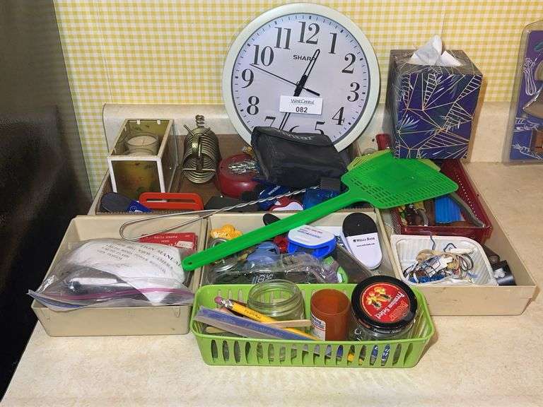 Household Items Including Clock, Camera, and Hand Tools image
