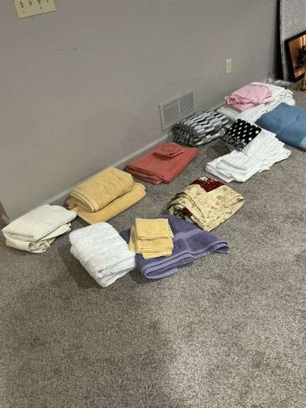 Assorted Sheets, Towels, and Blue Blanket image