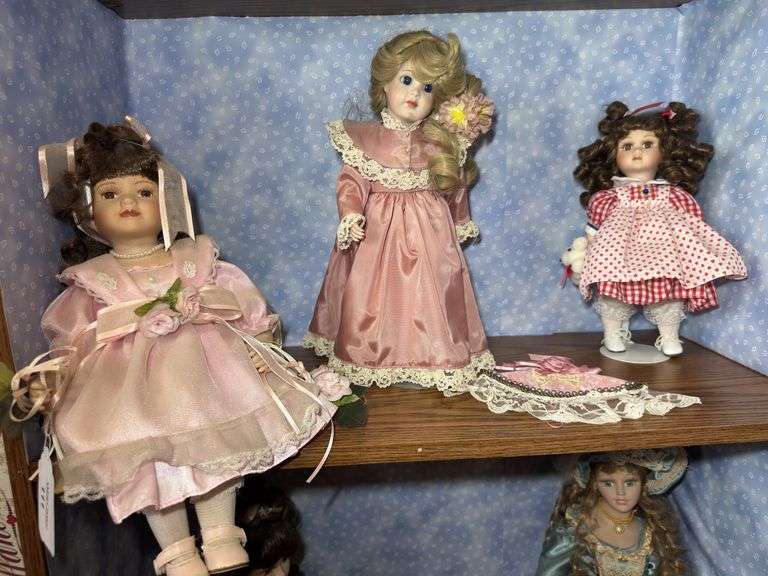 Collection of Three Porcelain Dolls with Accessories image