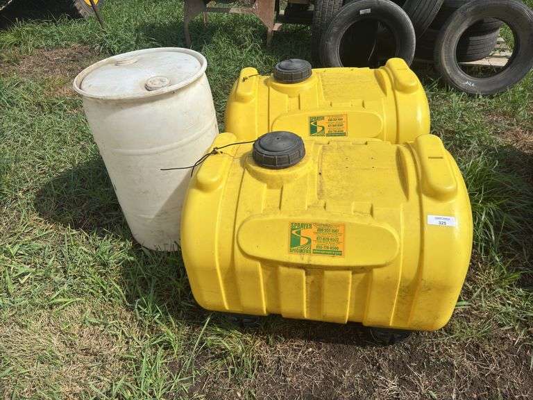 Two 60 Gallon Yellow Ace Roto-Mold Sprayer Tanks and One Plastic Barrel image
