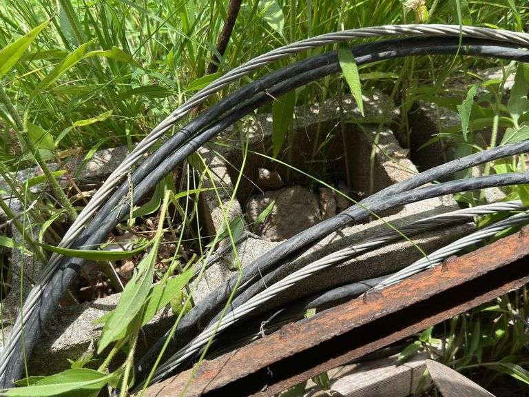 Farm Salvage Lot with Electrical Wire and Shovel