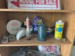 Contents of shelf with 'House for Sale' Sign, Tools, and Supplies