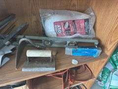 Contents of shelf with 'House for Sale' Sign, Tools, and Supplies