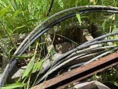 Farm Salvage Lot with Electrical Wire and Shovel