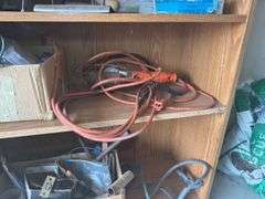 Contents of shelf with 'House for Sale' Sign, Tools, and Supplies