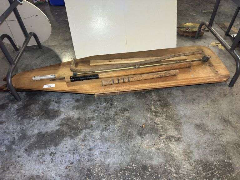 Assorted Wooden Handles, Sticks, and Ironing Board image