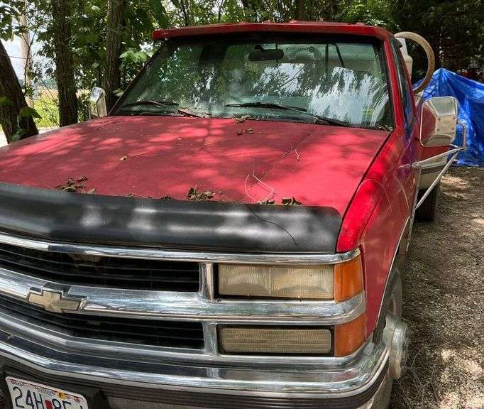 Red 1995 Chevrolet C3500 Dually Truck. Has salvage title.