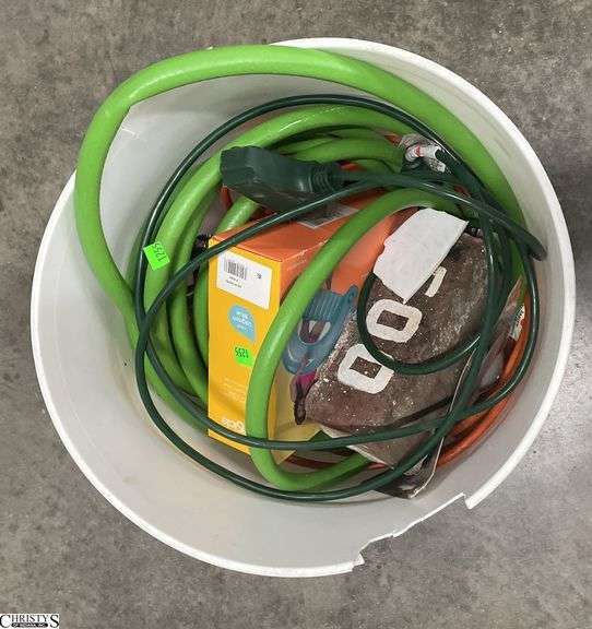 Bucket of garden hoses and pool float image