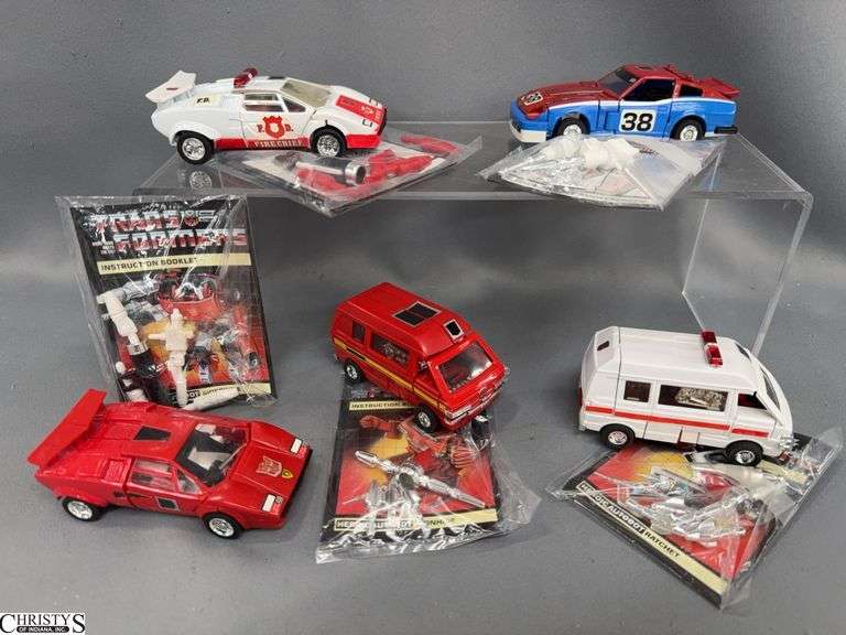 Transformers, Ironhide, Ratchet, Red Alert, Smokescreen, Sideswipe With Books and Weapons image
