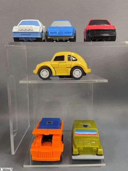 Vintage Transformers  Throttlebots Chase (red Ferrari Testarossa), Freeway (blue Chevrolet Corvette C4), Rollbar (green Jeep CJ-7), Searchlight (white Ford RS200), Wideload (orange mining dump truck), and Goldbug (a rebuilt Bumblebee image