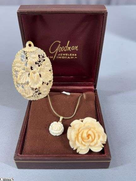 3 Pieces of Bone Looking Jewelry- A Carved Flower Pendant on a Gold Colored Chain, a Carved Flower Pin and a Carved Floral Pendant image