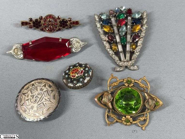 6 Fashion Brooches.  One brooch is marked 925 Made in Mexico.  One is a micro mosaic floral design brooch.  There are 2 silver toned brooches with colored stone/stones and 2 gold tone brooches with colored stones. image